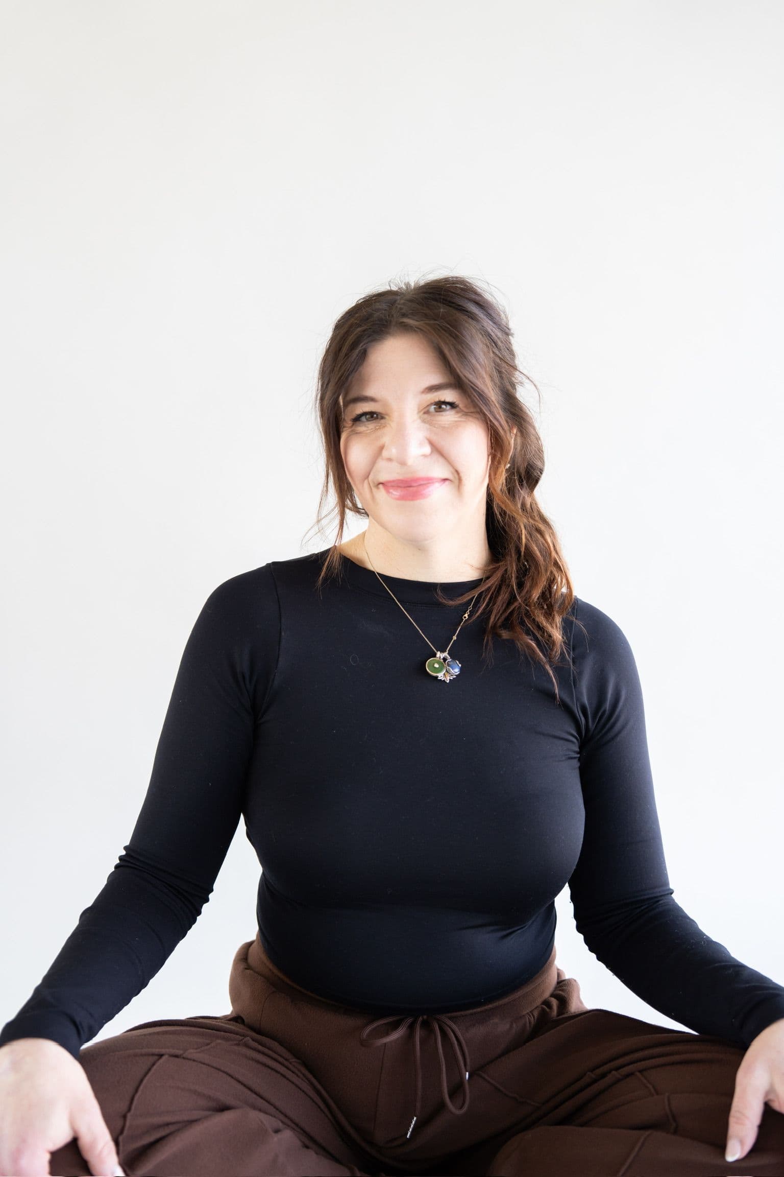 Yoga student seated cross-legged in a calm meditation pose