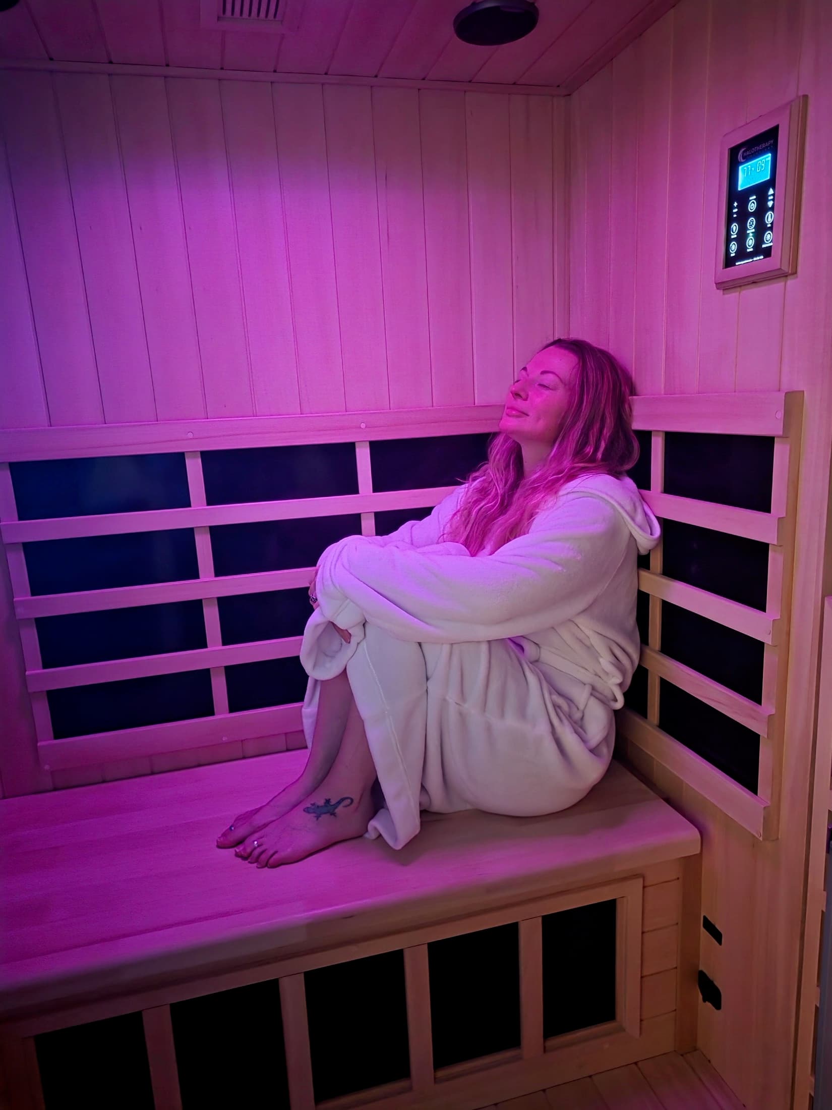 Warmly lit detail of the infrared halotherapy space and bench seating.