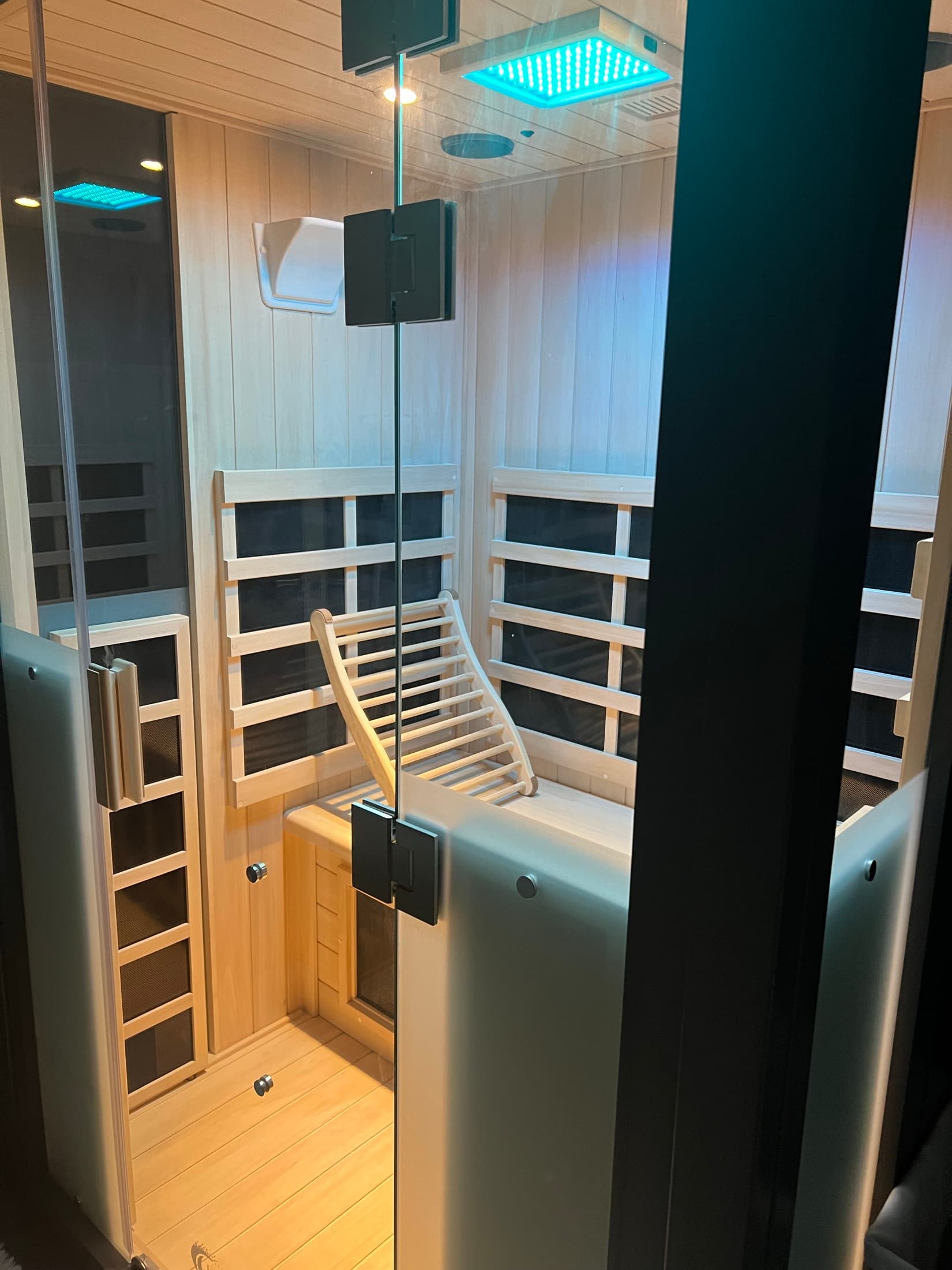 Guest relaxing in the infrared halotherapy room under deep red light.