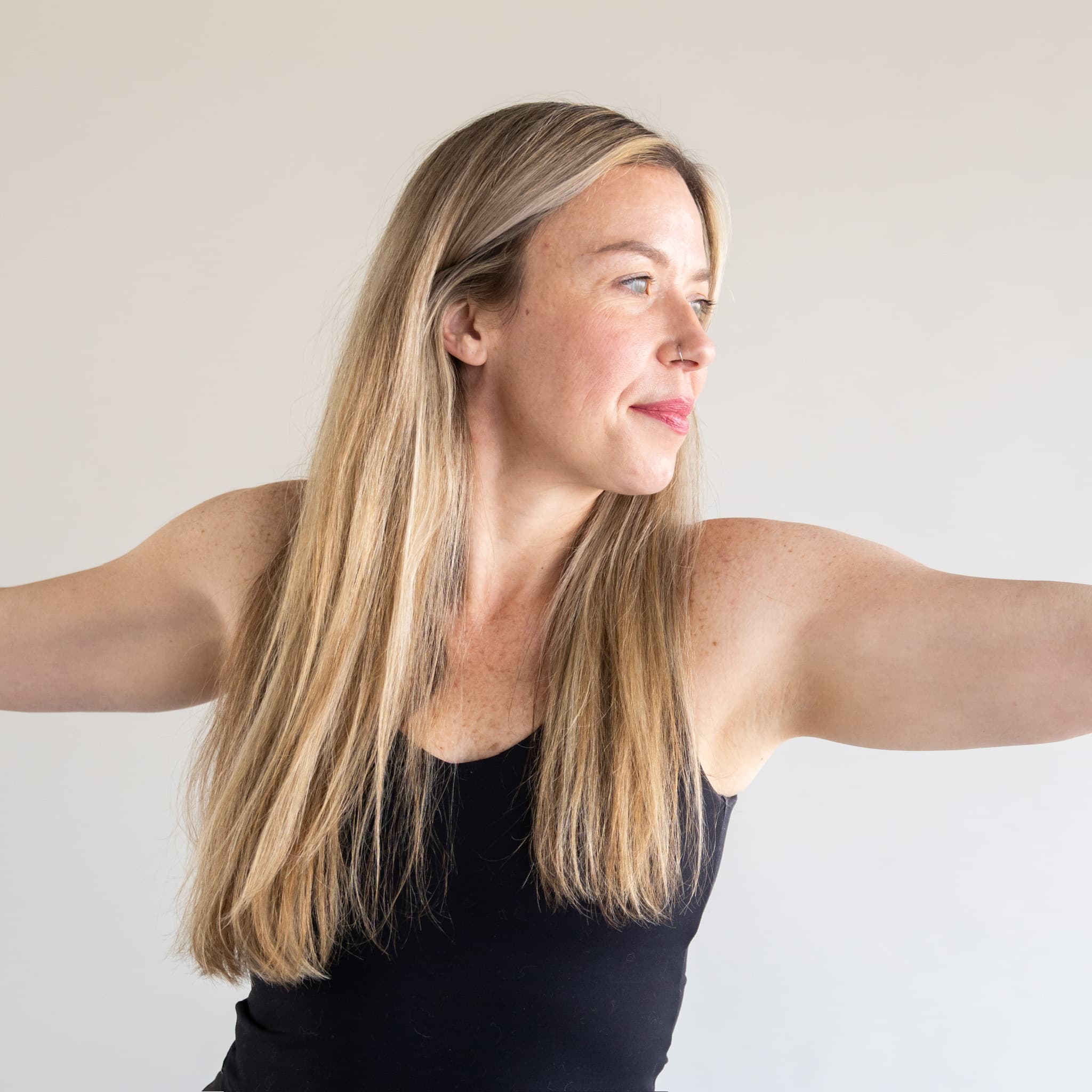 SPACE Yoga student practicing with arms extended in the studio